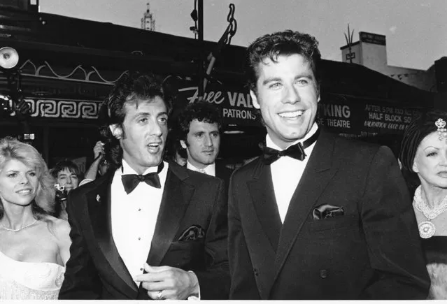 John Travolta, right, Sylvestor Stallone and his wife, Sasha, are  seen arriving at the world premiere of their movie “Staying Alive” in Hollywood, Ca., on July 11, 1983. Stallone wrote, directed and produced the movie.  The premiere is a benefit for The Stallone Fund for Autism research. Stallone's brother Frank can be seen in the background. (Photo by Nick Ut/AP Photo)
