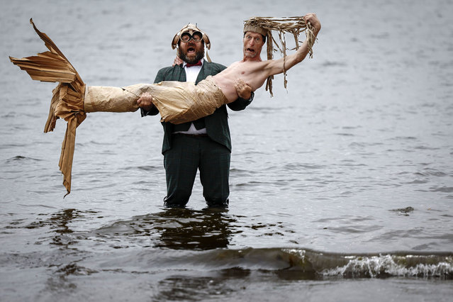 Olivier Martin-Salvan and Pierre Guillois dressed as a mermaid, mark the start of Moliere award-winning The Ice Hole A Cardboard Comedy as they visit Portobello beach on July 31, 2023 in Edinburgh, Scotland. From the creators of previous Fringe show Fishbowl, this new show is told using a thousand pieces of cardboard as the duo recount an epic journey from the fjords of Iceland to the dust of the Spanish desert.  (Photo by Jeff J. Mitchell/Getty Images)