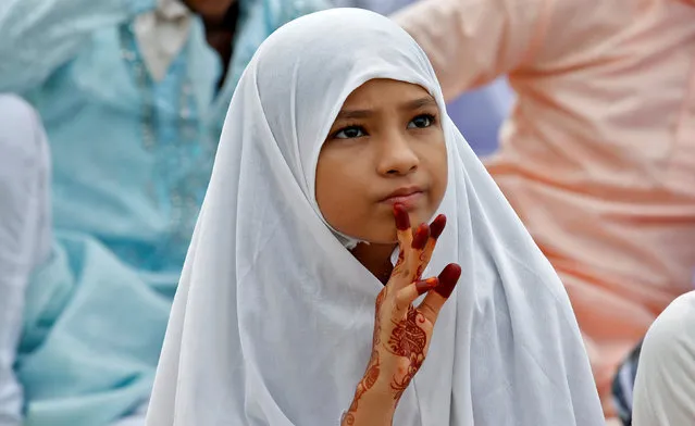 A Muslim girl attends Eid al-Fitr prayers to mark the end of the holy fasting month of Ramadan, in Kolkata, India, July 7, 2016. (Photo by Rupak De Chowdhuri/Reuters)