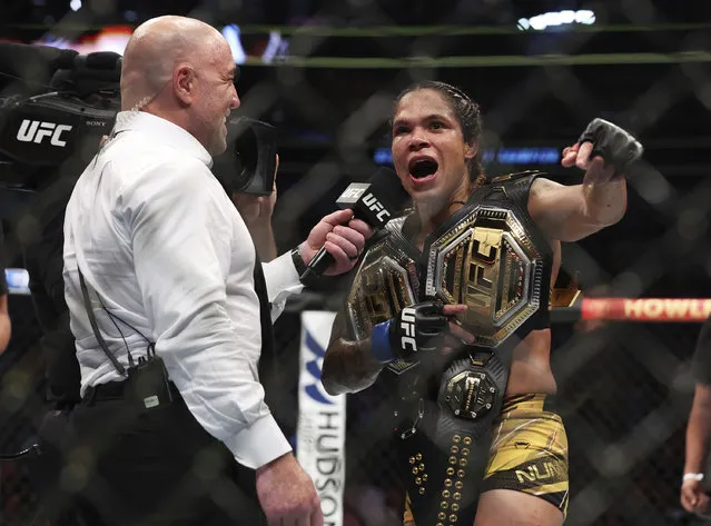 Joe Rogan interviews Amanda Nunes after her victory over Julianna Pena in a mixed martial arts women's bantamweight title bout at UFC 277 on Saturday, July 30, 2022, in Dallas. (Photo by Richard W. Rodriguez/AP Photo)