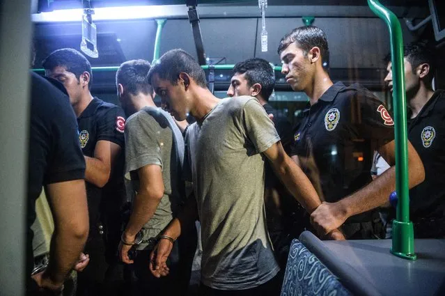 Turkish anti riot police officers detain Turkish soldiers who allegedly took part in a military coup as they are leaving in a bus the courthouse at Bakirkoy district in Istanbul on July 16, 2016. President Recep Tayyip Erdogan battled to regain control over Turkey on July 16, 2016 after a coup that claimed more than 250 lives, bid by discontented soldiers, as signs grew that the most serious challenge to his 13 years of dominant rule was faltering. (Photo by Ozan Kose/AFP Photo)