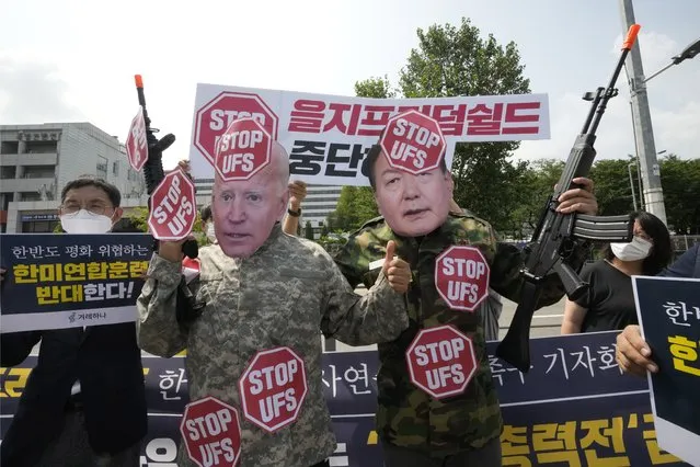 Protesters, two of which are wearing masks of U.S. President Joe Biden, left, South Korean President Yoon Suk Yeol, stage a rally to oppose planned joint military exercises, called the Ulchi Freedom Shield, between South Korea and the United States on the occasion of U.S. House of Representatives Speaker Nancy Pelosi's visit in South Korea, in front of the presidential office in Seoul, South Korea, Thursday, August 4, 2022. The banner reads, “Stop the Ulchi Freedom Shield”. (Photo by Ahn Young-joon/AP Photo)