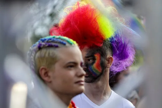 A couple listens to music after marching in the Bucharest Pride Parade, a LGBTQ+ event held in Bucharest, Romania, July 9, 2022. (Photo by Octav Ganea/Inquam Photos via Reuters)