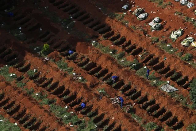Gravediggers open new graves as the number of dead rose after the coronavirus outbreak, at Vila Formosa cemetery, Brazil's biggest cemetery, in Sao Paulo, Brazil, April 2, 2020. (Photo by Amanda Perobelli/Reuters)