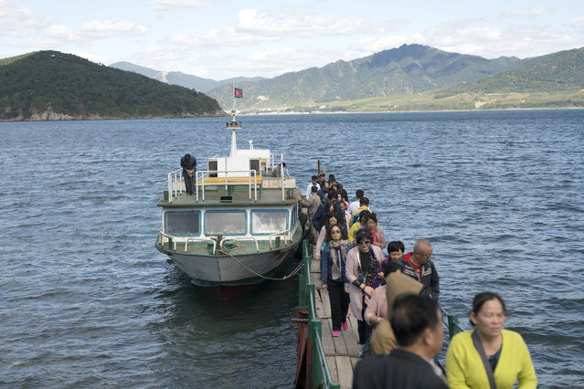 In this Tuesday, September 12, 2017, photo, Chinese tourists disembark from a tour boat at Rajin port in Rason Special Economic Zone, North Korea. (Photo by AP Photo)