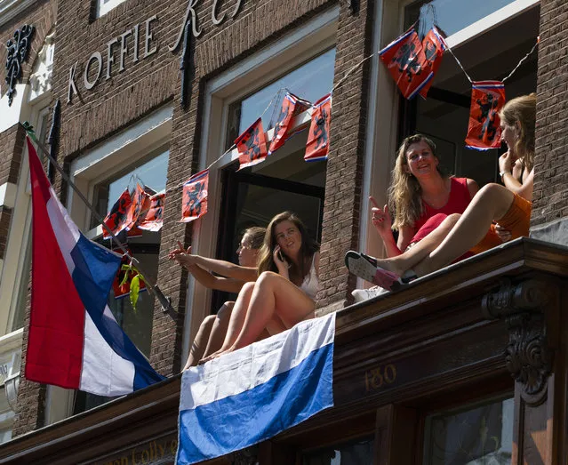 Four women celebrate King's Day at home in Amsterdam Netherlands, Monday, April 27, 2020. (Photo by Peter Dejong/AP Photo)
