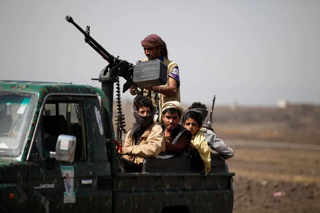 Houthi fighters ride on the back of a patrol truck as they secure the site of a pro-Houthi tribal gathering in a rural area near Sanaa, Yemen July 21, 2016. (Photo by Khaled Abdullah/Reuters)