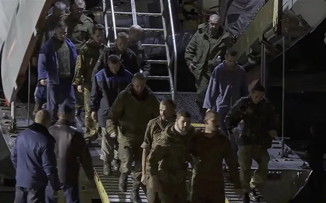 A still image taken from a handout video provided by the Russian Defence Ministry press-service shows a group of Russian prisoners of war (POW) disembarking a military aircraft after their exchange, at Chkalovsky Air Base near Moscow, Russia, 22 September 2022. Russia's Defence Ministry announced that 55 servicemen of the Armed Forces of the Russian Federation, the self-proclaimed Donetsk and Lugansk republics were released in a prisoner exchange with Ukraine. (Photo by Russian Defence Ministry Press Service/EPA/EFE)