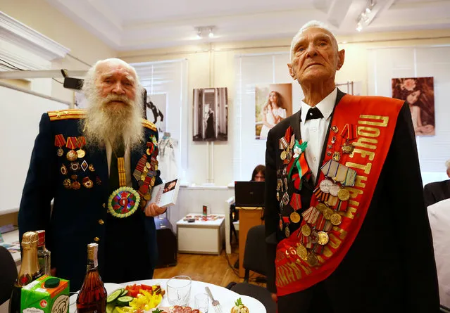 Belarussian World War II veterans Vasily Molodtsov (R) and Nikolay Skatulin pose for a photo during the event to mark the 71st anniversary of the country's liberation from Nazi Germany in Minsk, Belarus May 5, 2016. (Photo by Vasily Fedosenko/Reuters)