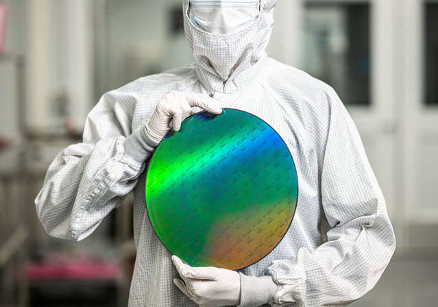 An employee of startup PsiQuantum holds a silicon disc containing the company's quantum computing chips at a facility in San Jose, California, in an undated handout photo provided on February 25, 2025. (Photo by Courtesy PsiQuantum/Handout via Reuters)