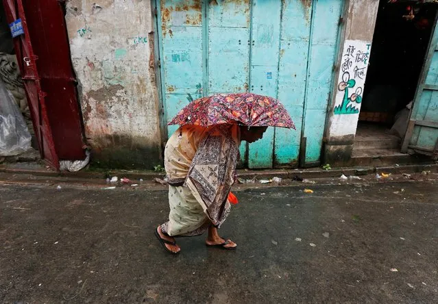 A woman walks on a street during rains in Kolkata, India, August 17, 2016. (Photo by Rupak De Chowdhuri/Reuters)