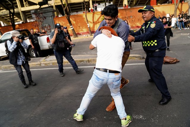 Protesters clash with attendees during a protest against the return of bullfighting, outside the Plaza de Toros Mexico bullfighting ring, in Mexico City, Mexico, on January 28, 2024. (Photo by Toya Sarno Jordan/Reuters)