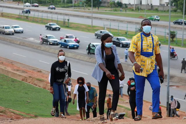 People go to work as authorities ease the lockdown following the coronavirus disease (COVID-19) outbreak in Abuja, Nigeria on May 4, 2020. (Photo by Afolabi Sotunde/Reuters)