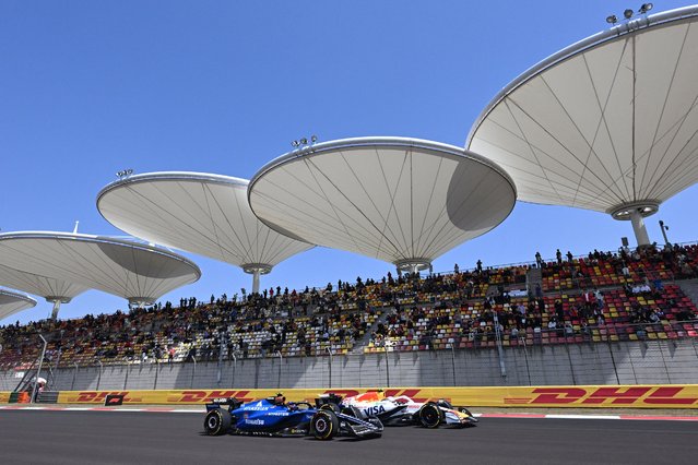Williams' Spanish driver Carlos Sainz (L) and RB's Japanese driver Yuki Tsunoda drive during the first practice session of the Formula One Chinese Grand Prix at the Shanghai International Circuit in Shanghai on March 21, 2025. (Photo by Jade Gao/AFP Photo)