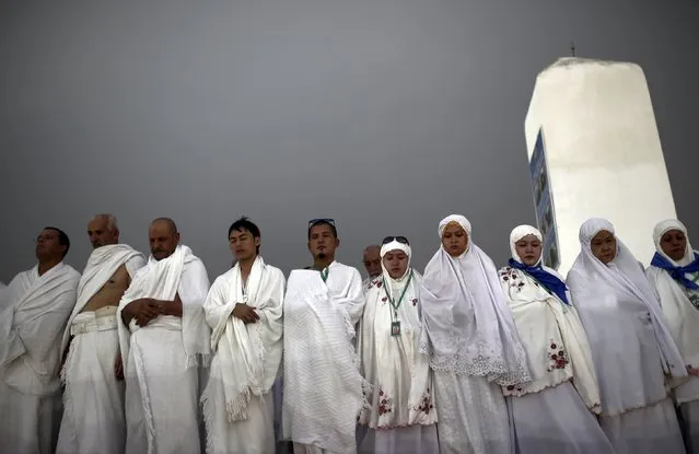 Muslim pilgrims pray on Mount Mercy on the plains of Arafat during the annual haj pilgrimage, outside the holy city of Mecca September 22, 2015. (Photo by Ahmad Masood/Reuters)