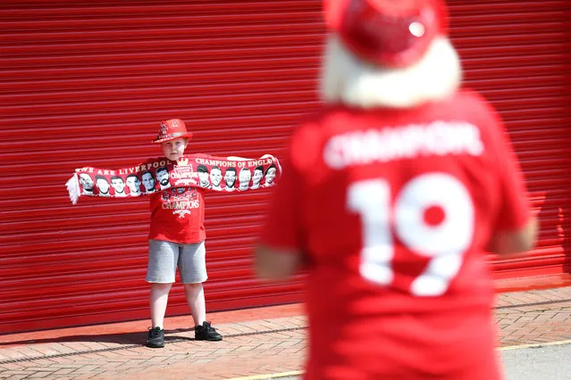 Liverpool fans Beryl Meland and grandson Archie outside Anfield in Liverpool on June 26, 2020. (Photo by Martin Rickett/PA Images via Getty Images)