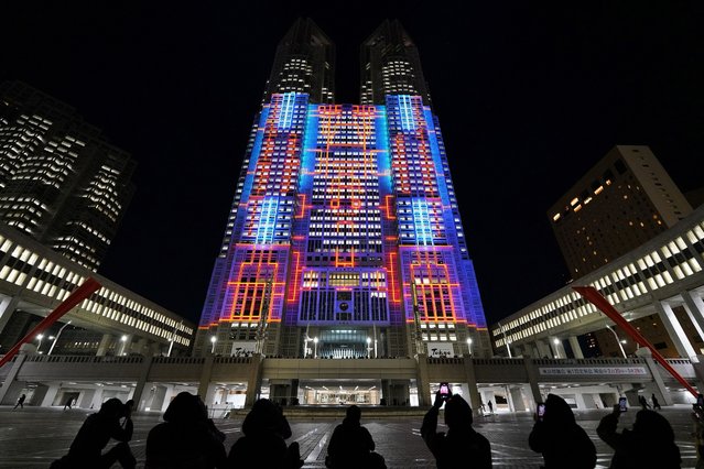The Tokyo Metropolitan Government Building No. 1 (C) is lit up with projection mapping which was recognized by Guinness World Records as the “largest architectural projection-mapped display” in Tokyo on February 26, 2024. (Photo by Kazuhiro Nogi/AFP Photo)