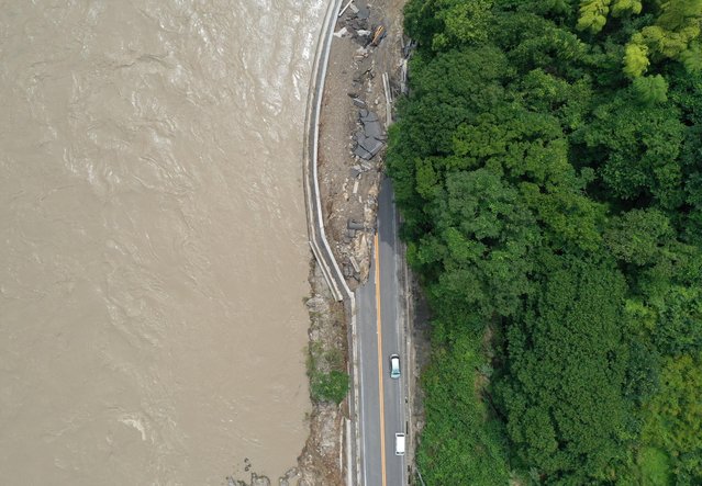 A view shows a damaged road after floods caused by torrential rain, in Kumamura, Kumamoto Prefecture, southwestern Japan, July 8, 2020. (Photo by Kim Kyung-Hoon/Reuters)