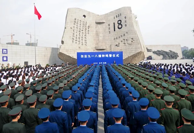 Soldiers and civilians stand in formation as they attend a memorial ceremony on the 84th anniversary of Japan's invasion of China, at the September 18th History Museum in Shenyang, Liaoning province September 18, 2015. (Photo by Reuters/Stringer)