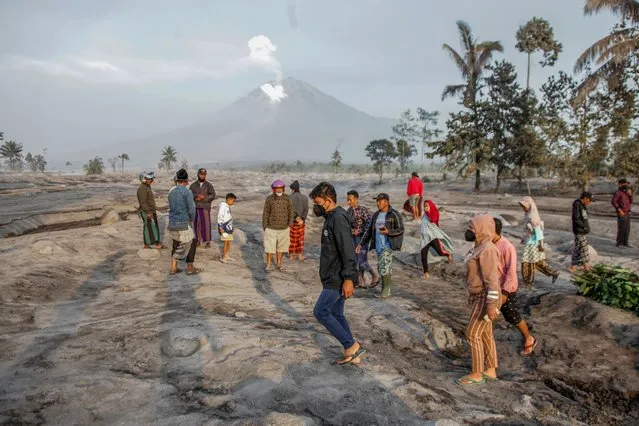Villagers inspect the area buried in volcanic ash from the eruption of Mount Semeru at Kajar Kuning village in Lumajang, East Java, Indonesia, 05 December 2022. Authorities has raised Mount Semeru alert status to the highest level following its eruption early on 04 December 2022 forcing around two thousands villagers to flee their home. The 3,376-metre Semeru is one of the most active volcanoes on Java island. (Photo by Susanto/EPA/EFE/Rex Features/Shutterstock)