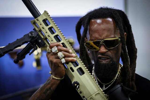 “Black Rambo” holds a gun during the NRA annual meeting in Atlanta, Georgia, U.S. April 25, 2025. (Photo by Jeenah Moon/Reuters)