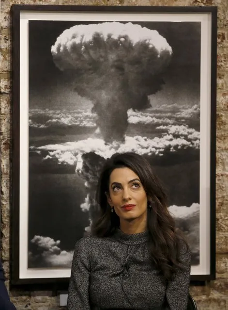 Lebanese lawyer Amal Clooney in front of a picture of an exploding atomic bomb where she is sat next to Canadian journalist Mohamed Fahmy (not pictured), who was recently freed from jail in Egypt, at an event at the Frontline Club in London, Britain, October 7, 2015. Fahmy, who was sentenced to three years in prison for operating without a press license and broadcasting material harmful to Egypt, was pardoned by Egypt's President Abdel Fattah al-Sisi in September. (Photo by Peter Nicholls/Reuters)
