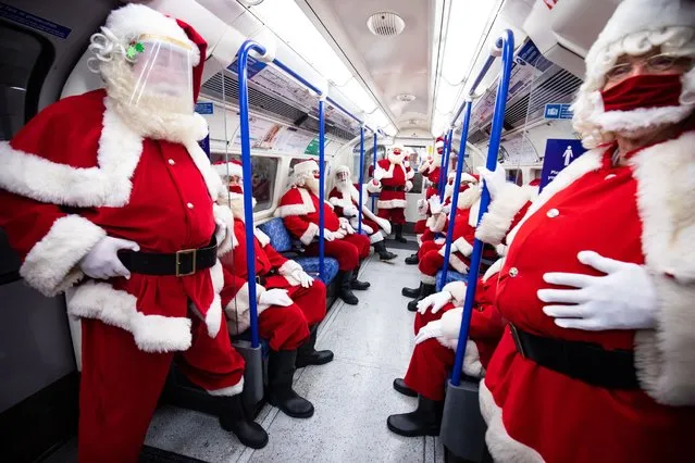 Members of the socially distant santa school travel to Southwark Cathedral, London on August 24, 2020. The Ministry of Fun's summer school aims to create COVID-safe Christmas grottos by teaching Father Christmases how to appear safely in person whilst maintaining the Christmas magic. (Photo by Aaron Chown/PA Images via Getty Images)