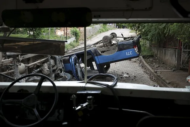 An overturned police vehicle is seen after clashes between striking miners and riot police at Mina El Limon town, Nicaragua October 8, 2015. A policeman died and 23 other officers were injured in clashes with protesters on Tuesday, the Nicaraguan police said, part of an ongoing labor dispute that has shut down operations at a Nicaraguan gold mine owned by Canada's B2Gold Corp. (Photo by Oswaldo Rivas/Reuters)