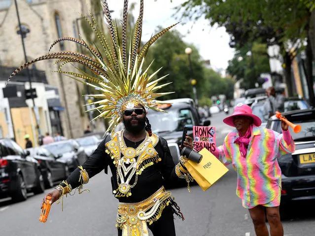 Revellers dressed in carnival costumes dance after the normal Notting Hill Carnival festivities was cancelled amid the coronavirus disease (COVID-19) outbreak, in London, Britain, August 31, 2020. (Photo by Toby Melville/Reuters)