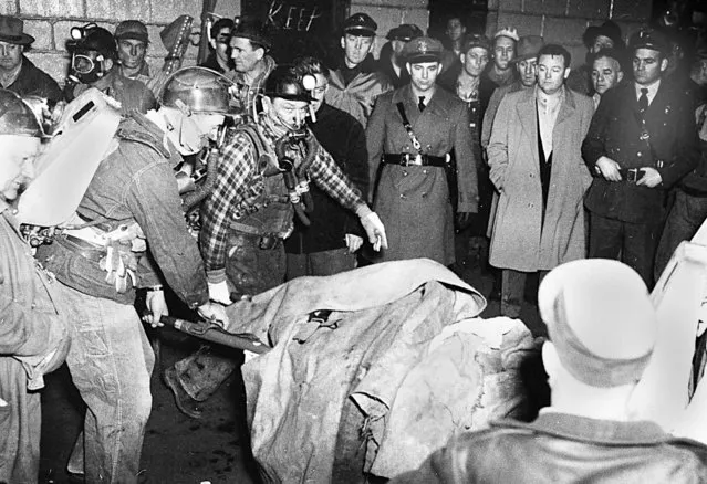Rescue workers pull a miner worker from the Orient No. 2 coal mine in West Frankfort, Ill., December 22, 1951, following an underground methane explosion. The state legislature passed the Illinois Mining Act of 1953, mandating better ventilation in underground mines and better testing for methane, which investigators said was the cause of the blast. Fifty years later, Dayton McReaken, a coal miner remembers when 119 workers died in the explosion. (Photo by AP Photo)