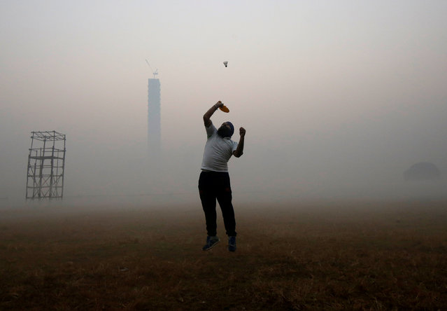 A man jumps to hit a shuttlecock inside a public park on a foggy winter morning in Kolkata, India, January 21, 2018. (Photo by Rupak de Chowdhuri/Reuters)