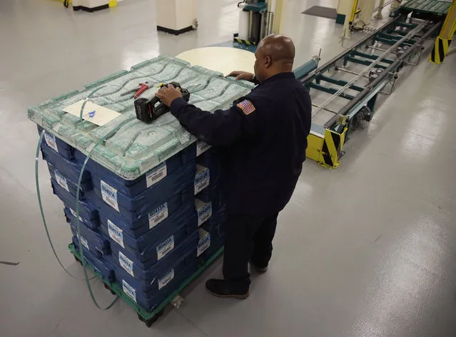 One dollar bills are loaded on a skid during production at the Bureau of Engraving and Printing in Washington November 14, 2014. This batch of currency is destined for the New York Federal Reserve Bank. (Photo by Gary Cameron/Reuters)