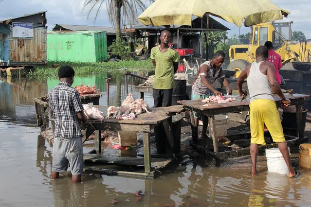 Men prepare chicken meat for sale in a flooded market at Effurun-Warri in Nigeria's Delta state, September 8, 2016. (Photo by /Reuters)