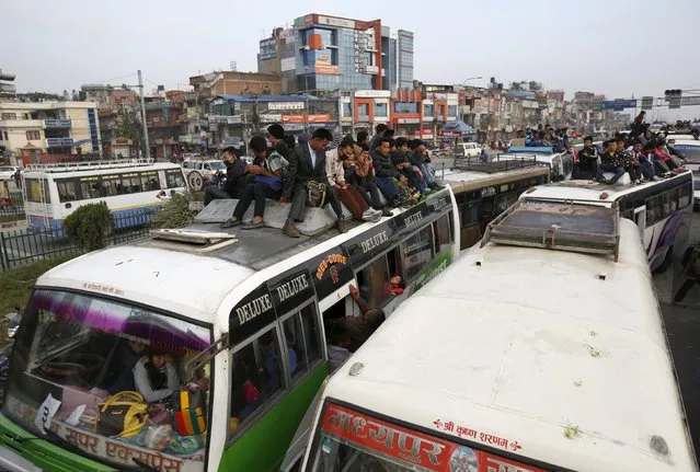 Passengers ride an overcrowded buses as they head towards their village to celebrate "Dashain", the biggest religious festival for Hindus in Nepal, as fuel crisis continues in Kathmandu, October 20, 2015. (Photo by Navesh Chitrakar/Reuters)