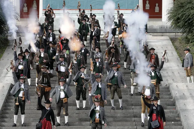 Bavarian riflemen and women in traditional costumes fire their muzzle loaders in front of the “Bavaria” statue on the last day at the 183rd Oktoberfest beer festival in Munich, southern Germany, Monday, October 3, 2016. (Photo by Matthias Schrader/AP Photo)