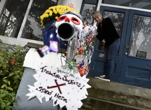 Carol McCarthy sends candy down the candy chute that she will use to give out treats to socially-distant trick-or-treaters on Halloween, Monday, October 26, 2020, in Palmyra, N.J. (Photo by Michael Perez/AP Photo)