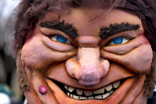 A large puppet of Argentine President Javier Milei is held by a protester outside a government depot for food storage where people gather to demand the release of supplies for soup kitchens, which depend on the government for some of their food supply, in Buenos Aires, Argentina, Wednesday, May 29, 2024. (Photo by Natacha Pisarenko/AP Photo)