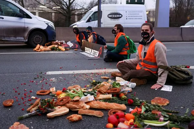 “Letzte Generation” (Last Generation) activists block a highway to protest against food waste and for an agricultural change to reduce agricultural greenhouse gas emissions, in Berlin, Germany, February 4, 2022. (Photo by Christian Mang/Reuters)