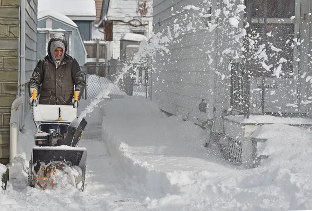 A man uses a snowblower to remove snow from his driveway after a snowstorm in Wilkes-Barre, Northeast PA. on December 17, 2020. A major snowstorm dumped over 15 inches in Wilkes-Barre, PA. The snow impacted driving and an emergency alert warned people to stay off the roads and seek shelter as snow was falling over a few inches an hour. (Photo by Aimee Dilger/SOPA Images/Rex Features/Shutterstock)