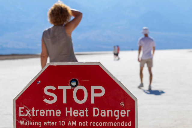 A person wipes sweat from their brow at Badwater Basin in Death Valley National Park, Calif., Sunday, July 7, 2024. Forecasters say a heat wave could break previous records across the U.S., including in Death Valley. (Photo by Ty ONeil/AP Photo)