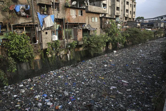 Garbage chokes a polluted canal in Mumbai, India, Monday, June 4, 2018. The theme for this year's World Environment Day, marked on June 5, is “Beat Plastic Pollution”. (Photo by Rafiq Maqbool/AP Photo)