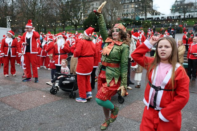 Members of the public dressed in santa suits take part in a fun run on December 07, 2025 in Edinburgh, Scotland. This years proceeds from the Edinburgh Santa Fun Run will be donated to the When You Wish Upon a Star Charity for children with life-threatening injuries. (Photo by Jeff J. Mitchell/Getty Images)