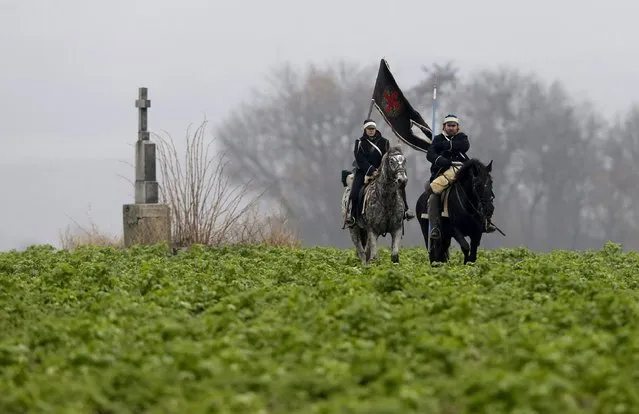 Historical re-enactment enthusiasts dressed as soldiers ride horses near the southern Moravian village of Herspice December 4, 2015. Hundreds of history enthusiasts gathered near the city of Slavkov before a re-enactment of Napoleon's famous battle of Austerlitz on Saturday to mark its 210th anniversary. (Photo by David W. Cerny/Reuters)