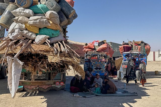 Afghan refugees sit next to their belongings loaded onto vehicles as they wait for the reopening of the border crossing point, which closed after Afghan and Pakistani security forces exchanged fire, at a camp in Chaman, Pakistan, Sunday, October 12, 2025. (Photo by AP Photo/Stringer)
