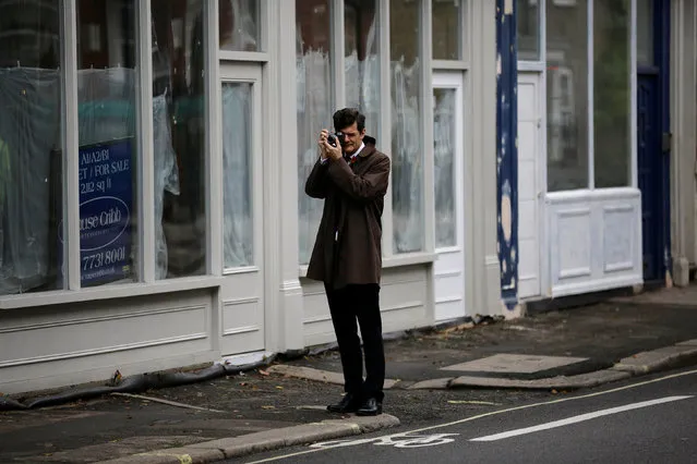 A man photographs a Remembrance Sunday parade through Fulham in West London, Britain November 8, 2015. (Photo by Kevin Coombs/Reuters)