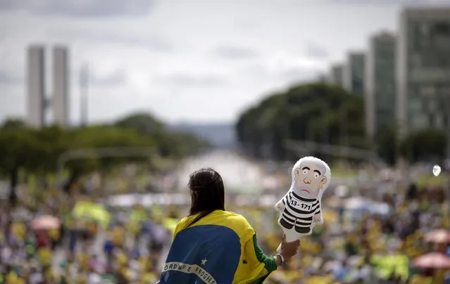 A demonstrator holds an inflatable doll of Brazil's former president Luiz Inacio Lula da Silva during a protest calling for the impeachment of Brazil's President Dilma Rousseff near the National Congress in Brasilia, Brazil, December 13, 2015. (Photo by Ueslei Marcelino/Reuters)