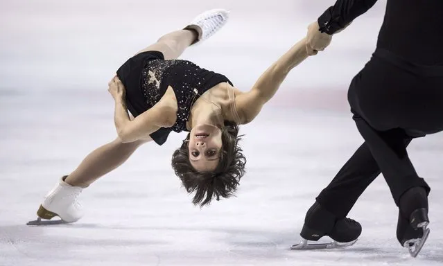 Meagan Duhamel is spun around by her partner Eric Radford as they perform their free program to win the gold medal in the pairs competition at the Canadian Figure Skating Championships, Saturday, January 24, 2015, in Kingston, Ontario. (Photo by Paul Chiasson/AP Photo/The Canadian Press)