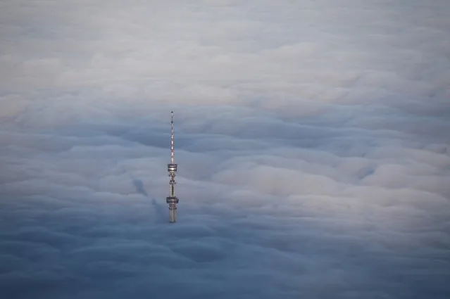 The Almaty television tower sticks out from a blanket of thick fog in Almaty, Kazakhstan, December 11, 2020. (Photo by Pavel Mikheyev/Reuters)
