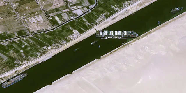 This satellite image from Cnes2021, Distribution Airbus DS, shows the cargo ship MV Ever Given stuck in the Suez Canal near Suez, Egypt, Thursday, March 25, 2021. The skyscraper-sized cargo ship wedged across Egypt's Suez Canal further imperiled global shipping Thursday as at least 150 other vessels needing to pass through the crucial waterway idled waiting for the obstruction to clear, authorities said. (Photo by Cnes2021, Distribution Airbus DS via AP Photo)