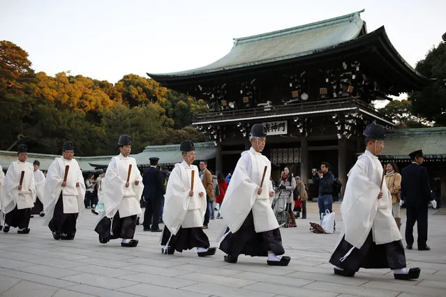 Shinto priests walk to the main shrine for a ritual to usher in the New Year at the Meiji Shrine in Tokyo, Japan, December 31, 2015. (Photo by Thomas Peter/Reuters)